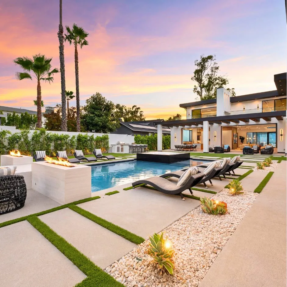 Luxury backyard pool design at sunset with custom lounge seating and modern residential architecture