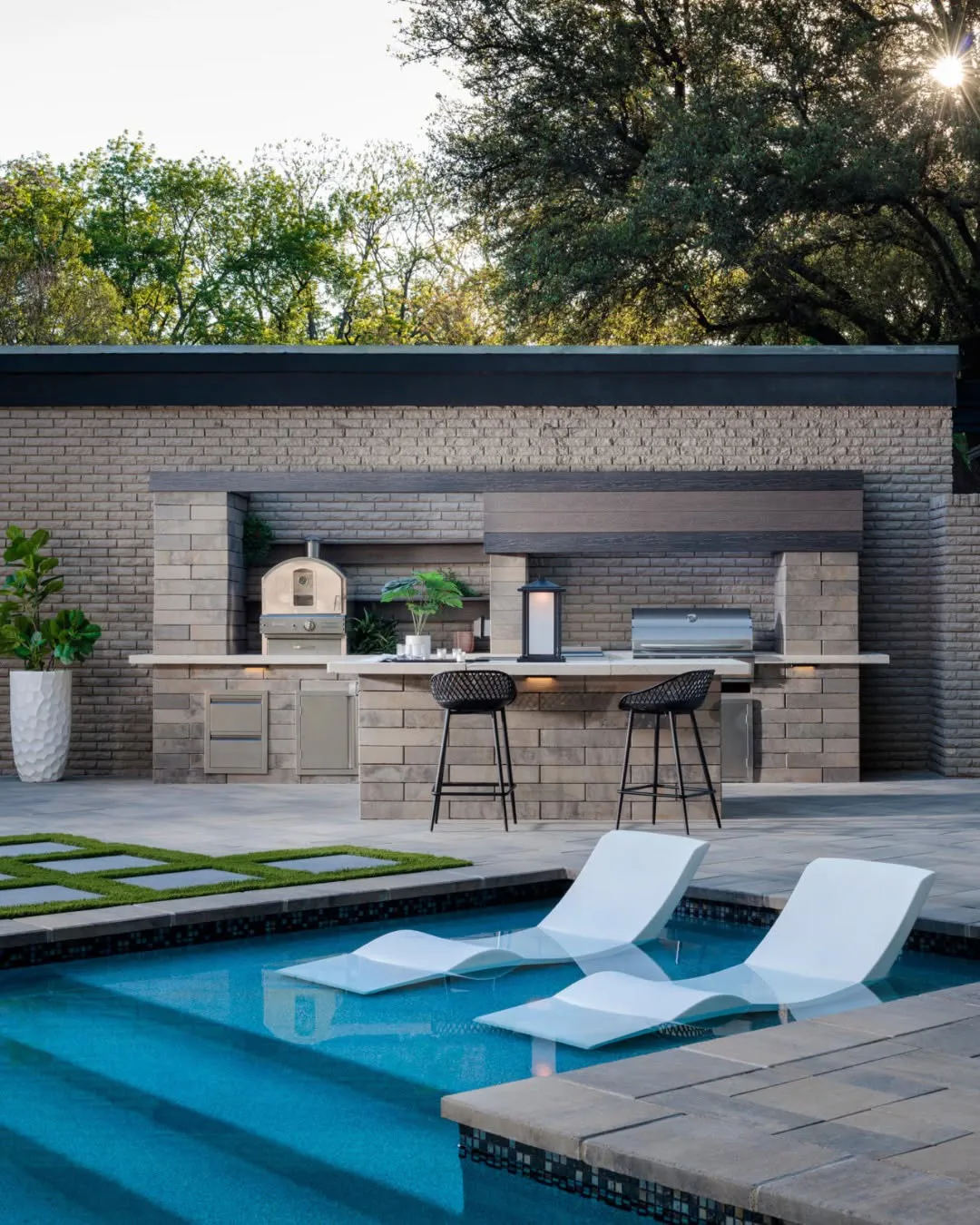 Get a Consultation Modern luxury backyard pool with integrated outdoor kitchen and lounge seating