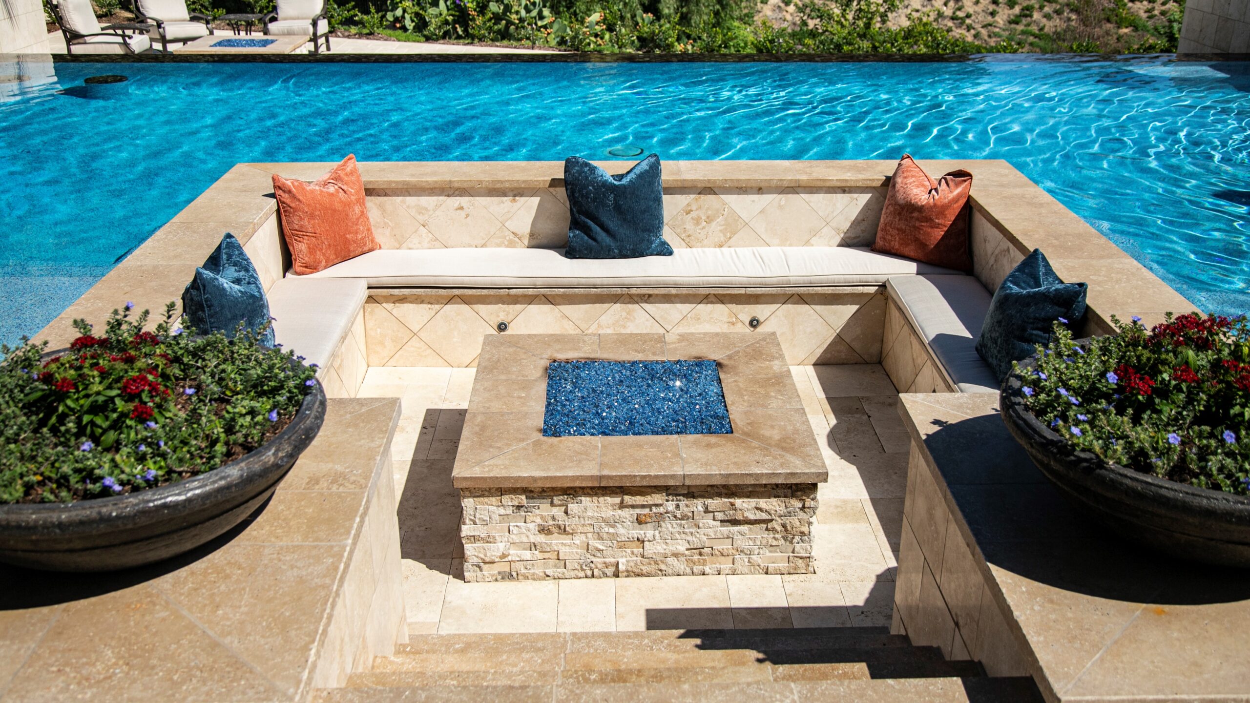 Luxury backyard pool with sunken seating area, fire pit, and resort-style outdoor living space